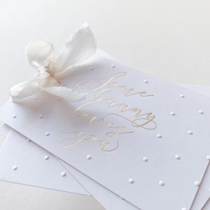 Smooth white card with silk ribbon.