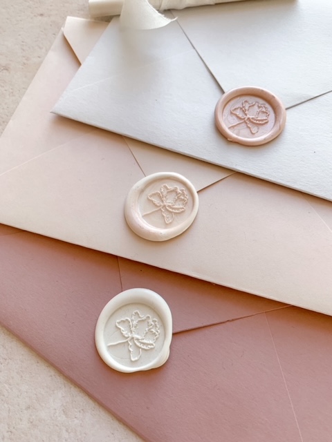 3 wax seals on different coloured envelope