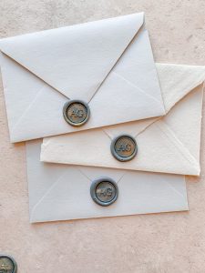 3 wax seals on grey coloured envelopes